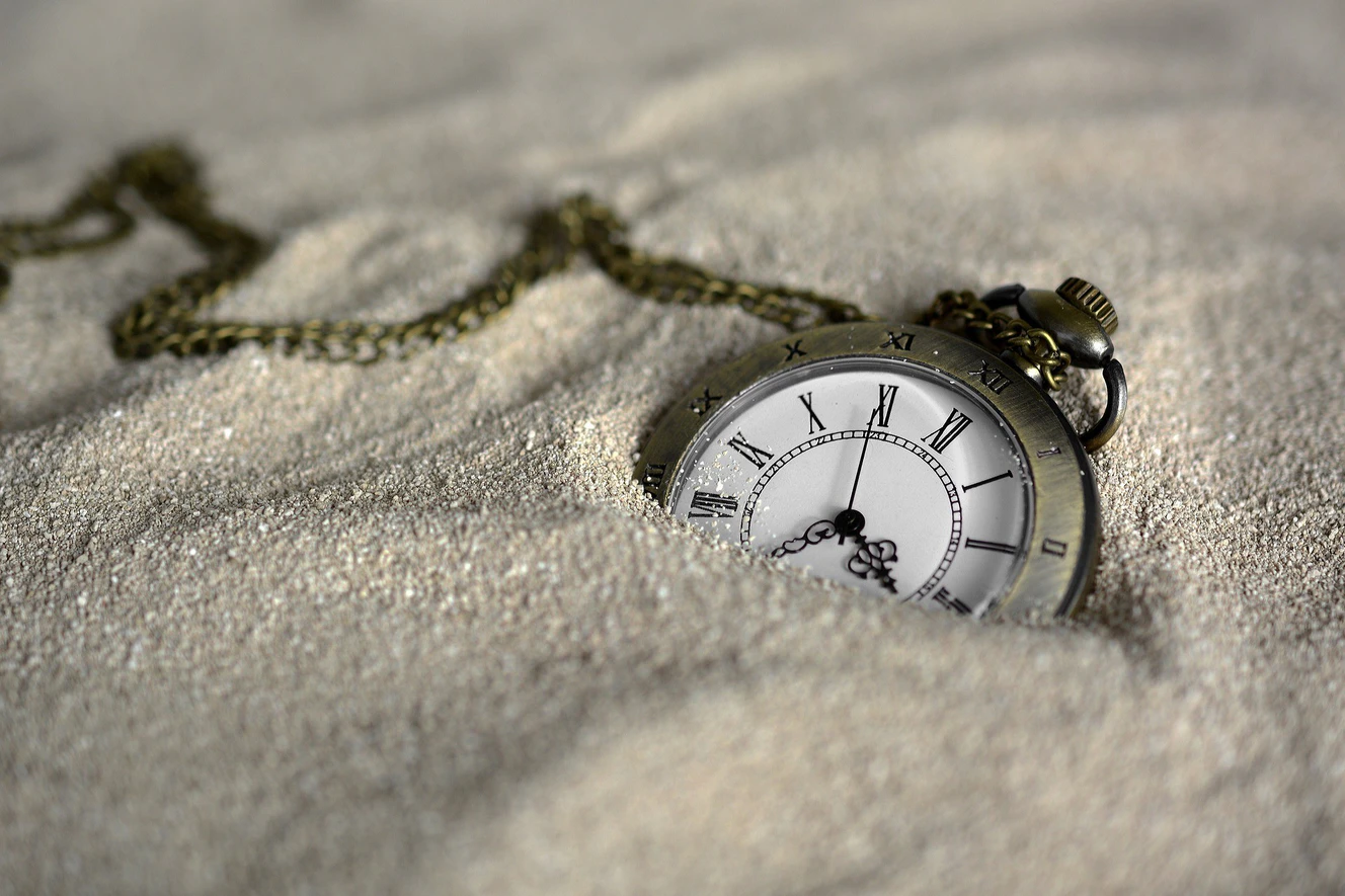 eine Taschenuhr im Sand — © Symbolbild