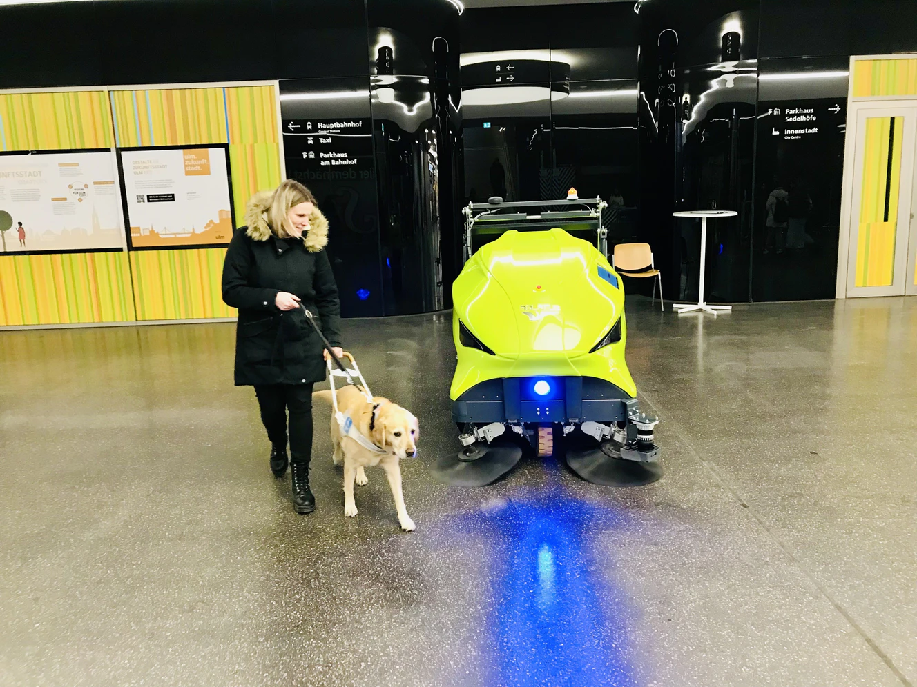 Diana Krause aus Ulm trifft mit ihrem Hund auf den Putzroboter "Cordula" in der Ulmer Sedelhofpassage.
