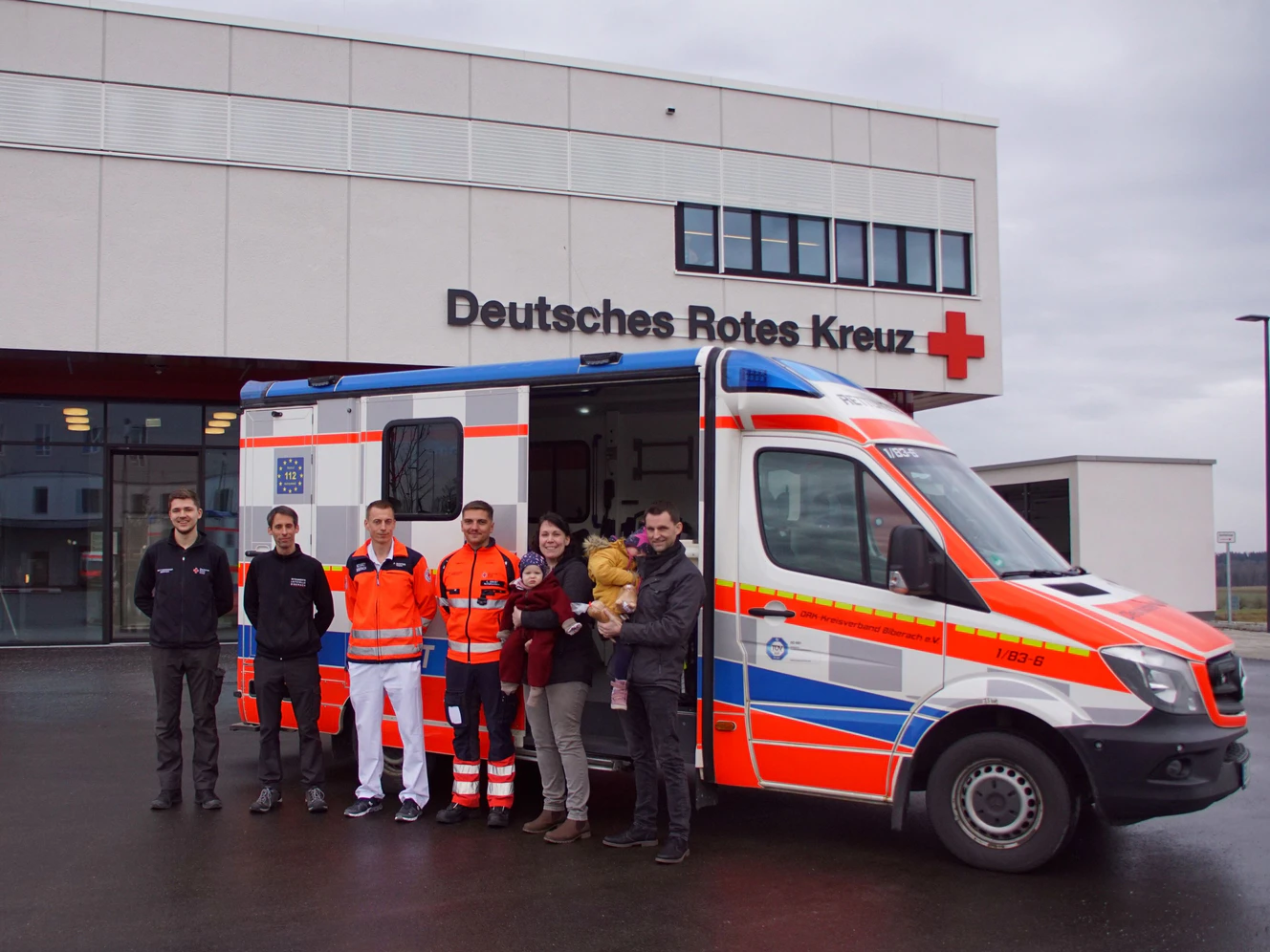 Jessica und Christian Nusser mit der dreijährigen Emma und der einjährigen Paula (rechts) bedanken sich bei Notarzt Philipp Ganter (Dritter von links), dem Disponenten Jörg Wunderlich (Zweiter von links) sowie den Notfallsanitätern Carolus Obert (Vierter von links) sowie Fabian Kosok (links). — © DRK BC